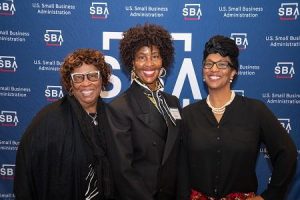 Wonderlyn Murphy with her mother and sister at the 2023 National Small Business Week Awards Breakfast at the Needham Sheraton